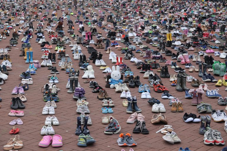 AMSTERDAM, NETHERLANDS - MAY 8: 15000 shoes have been laid in front of Booking.com headquarters, organized by Plant an Olive tree for Palestine as they represent the 15000 children who died in Gaza and more than 100 in West Bank, in Amsterdam, Netherlands on May 8, 2024. The location was selected due to Booking.com includes properties from settlers in the West Bank. (Photo by Nikos Oikonomou/Anadolu via Getty Images)